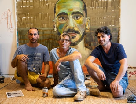 Mostafa Azimitabar, Angus McDonald and Farhad Bandesh, in front of Azimitabar’s self-portrait which was a finalist of the 2022 Archibald Prize.