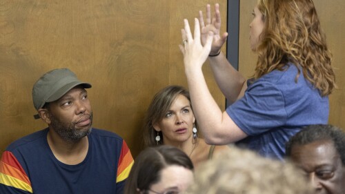 Ta-Nehisi Coates and Mary Wood, a teacher at Chapin High School, speak with Wood's supporters before a meeting of the Lexington-Rchland 5 school board on Monday, July 17, 2023 in Irmo, S.C. Coates sat silently through a school board meeting in South Carolina to support the high school teacher told to stop using his book on racism and growing up Black in America in her advanced English class. (Joshua Boucher/The State via AP)