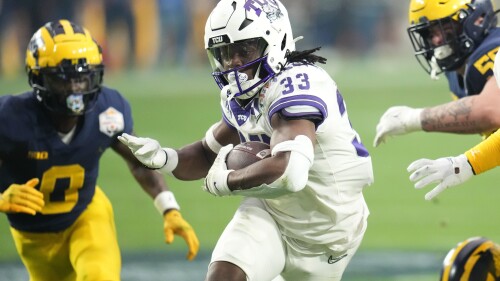 FILE - TCU running back Kendre Miller (33) runs against Michigan during the first half of the Fiesta Bowl NCAA college football semifinal playoff game, Saturday, Dec. 31, 2022, in Glendale, Ariz. New Orleans Saints general manager Mickey Loomis says third-round draft choice Kendre Miller and fourth-round draft choice Nick Saldiveri are among a handful of players the club has placed on injury lists with a week left before the opening of training camp, Tuesday, July 18, 2023. (AP Photo/Ross D. Franklin, File)