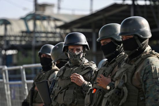 Military forces stand guard outside the Guayas 1 prison, where a dayslong riot between rival gangs claimed at least 18 lives, in the port city of Guayaquil, Ecuador, on July 25.