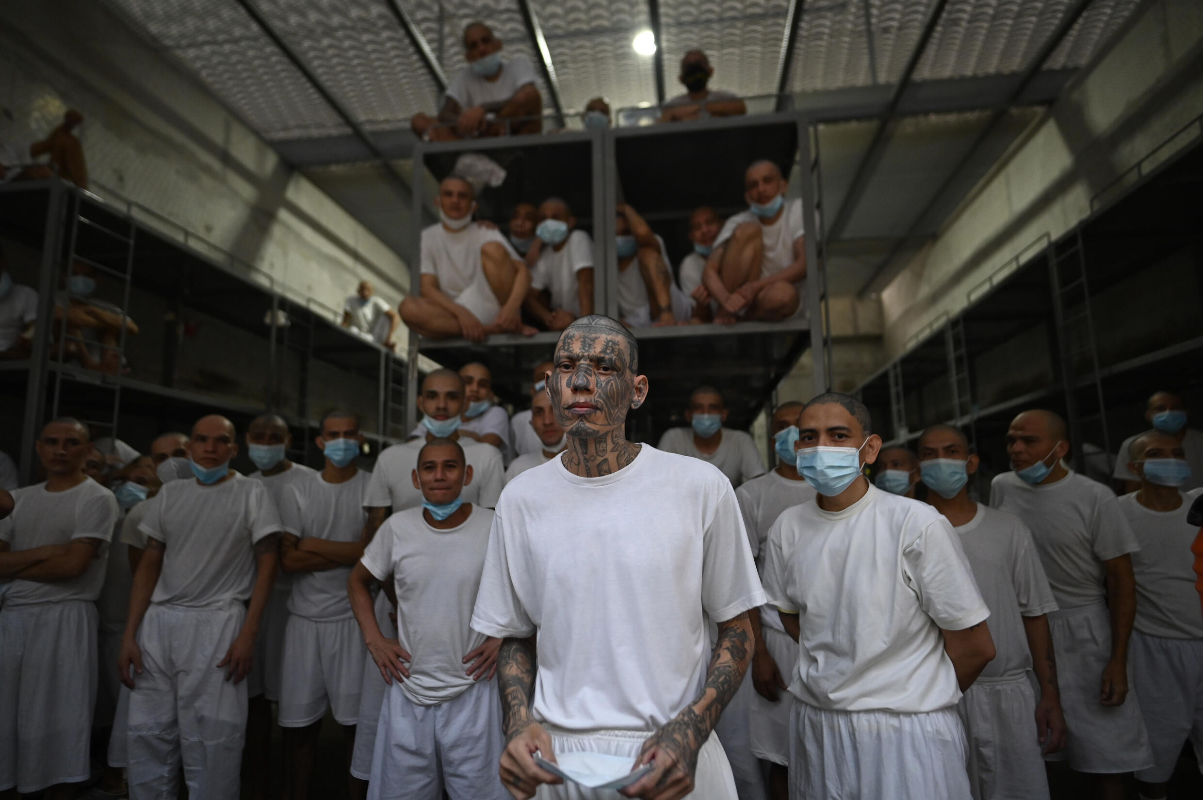 Inmates in El Salvador's new mega prison peer out from a cell