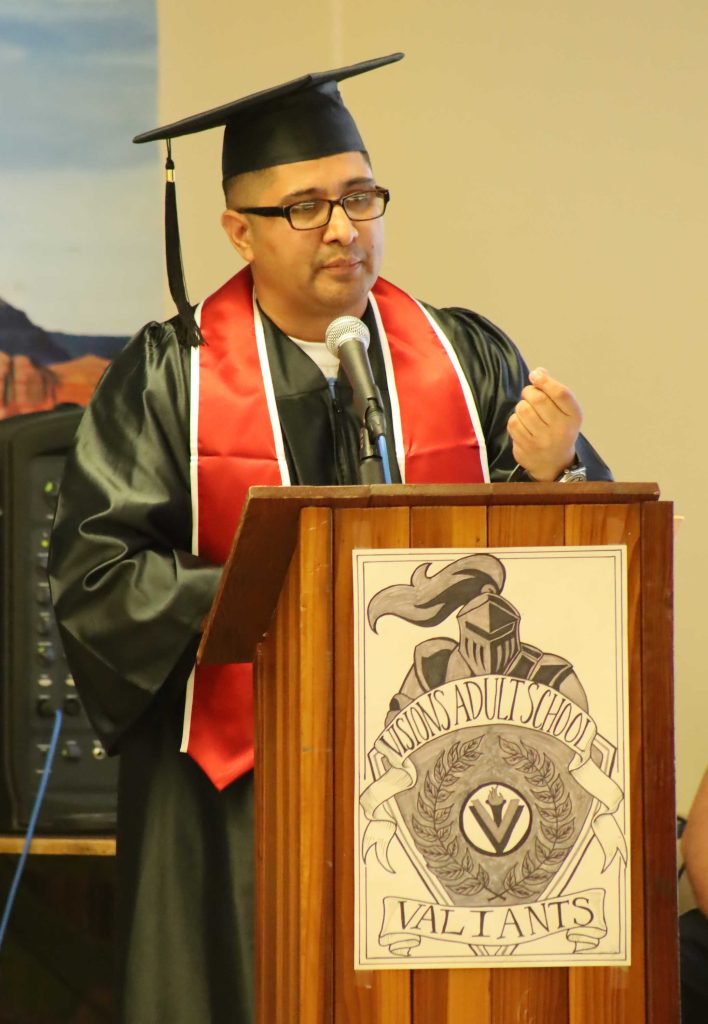 COR graduate speaks at a ceremony.