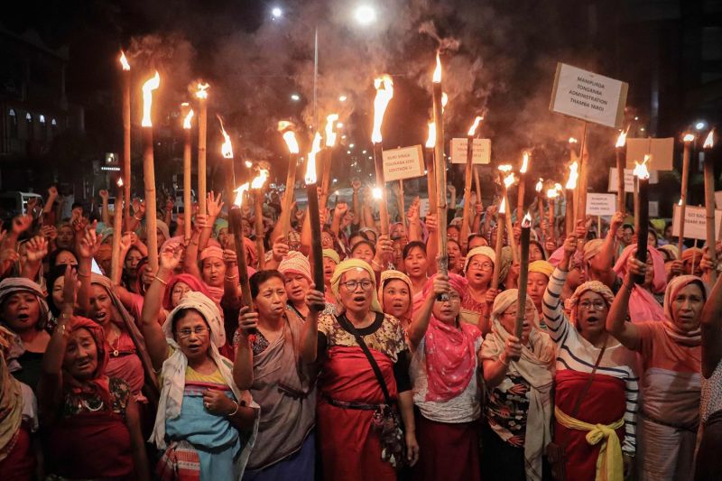 Women belonging to the 'Meira Paibis', a group of women representing Meitei society, hold torches during a demonstration demanding the restoration of peace in India's north-eastern Manipur state in Imphal, following ongoing ethnic violence in the state on Aug. 9.