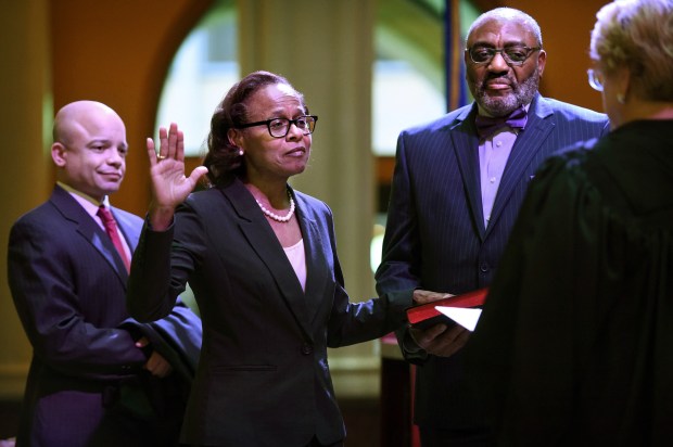 Natalie Hudson raises her right hand as she is sworn in to the Minnesota Supreme Court.