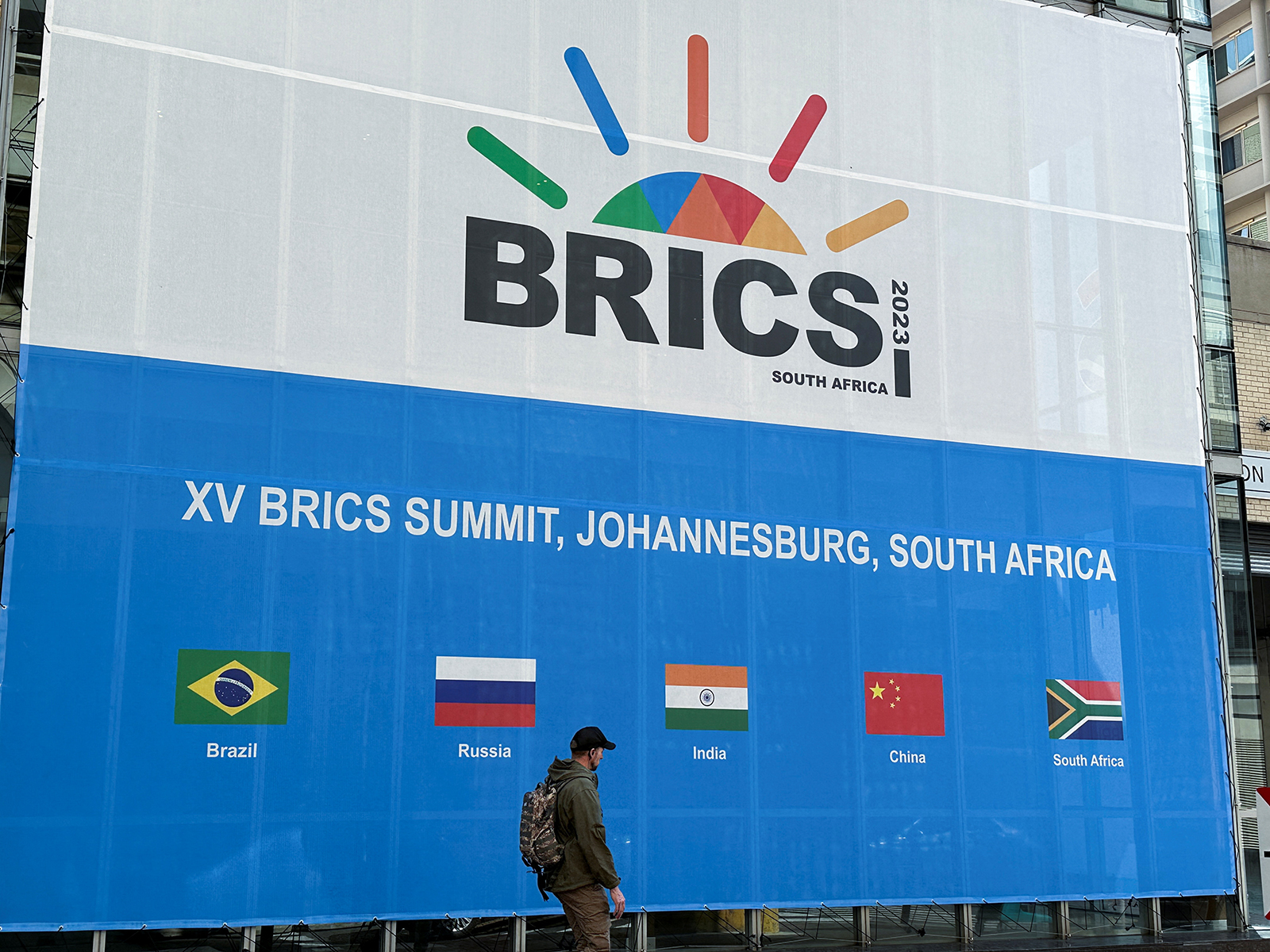 A person walks past the Sandton Convention Centre in Johannesburg, South Africa on August 19.