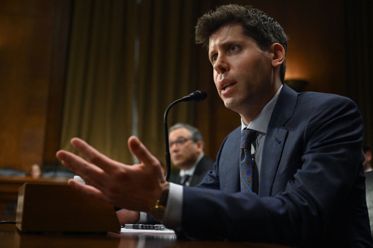 Samuel Altman gestures while testifying at a hearing