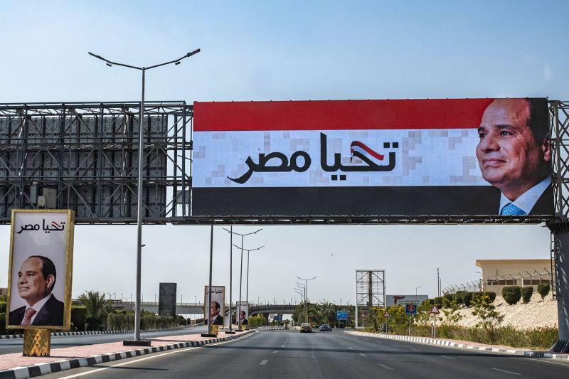 Signs with Egyptian President Abdel Fattah al-Sisi’s face and the slogan “Long live Egypt” are seen along a road outside Cairo International Airport on May 13.