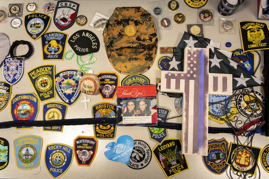 A memorial to Sgt. Alex Hamzy and Lt. Dustin DeMonte is on display at the Bristol Police Department. After they were killed during an ambush last October, police officers from all over the country sent their badges to Bristol as symbols of love and support to honor the fallen officers.