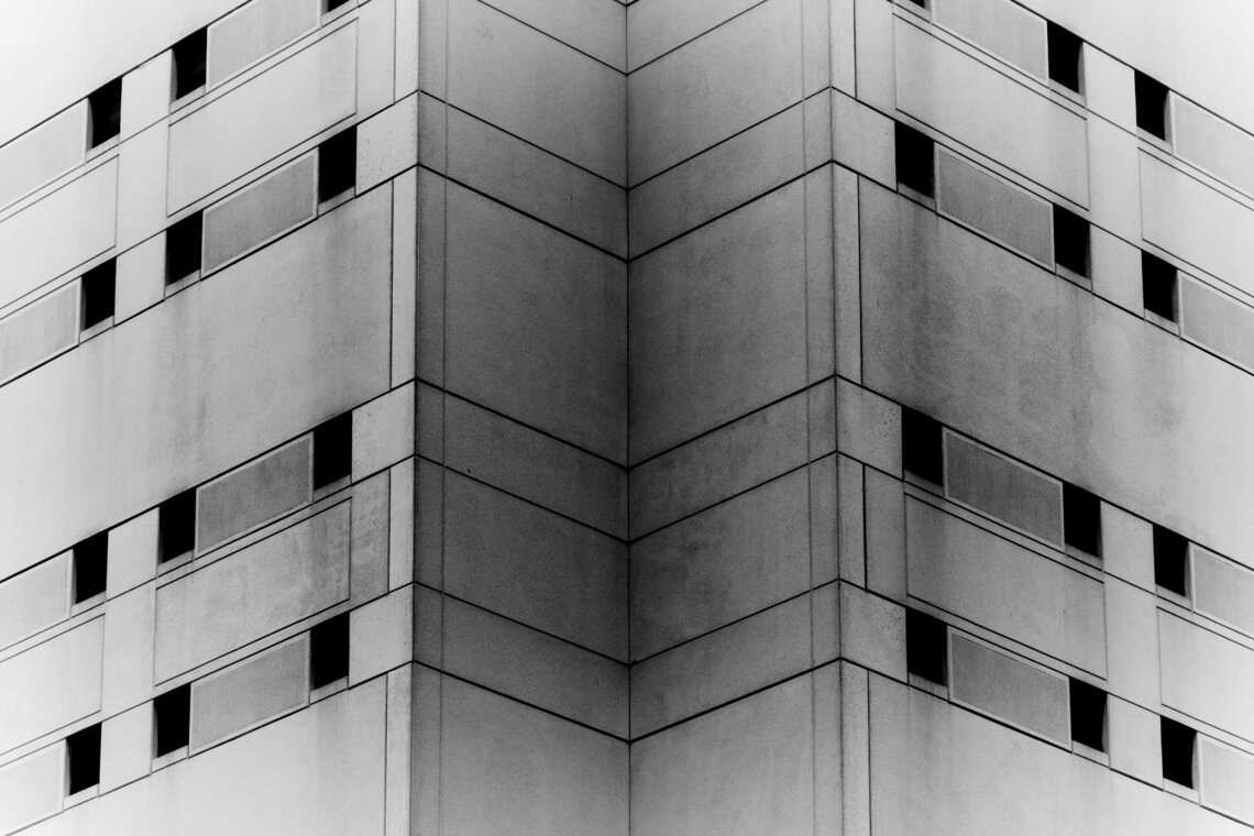 A zoomed in black and white photo shows windows on two sides of the Cuyahoga County Jail. 