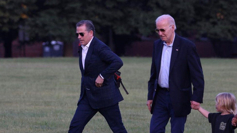 Hunter Biden and U.S. President Joe Biden, holding the hand of his grandson Beau Biden Jr