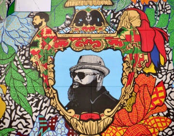 Black Thought is the central figure in a 4-story mural on the south side of the new Clay Studio building in Kensington. Profiles of Black poets Sonia Sanchez and Amiri Baraka are worked into the handles of the vase.(Emma Lee/WHYY)