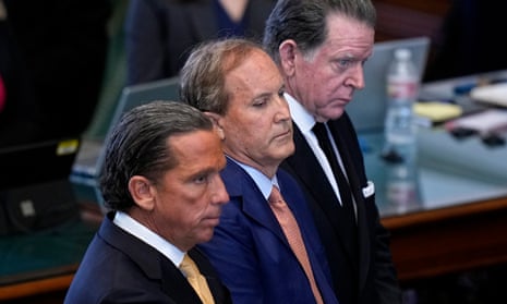 The Texas attorney general, Ken Paxton, is flanked by his attorneys as the articles of his impeachment are read in the senate chamber at the Texas capitol last week.