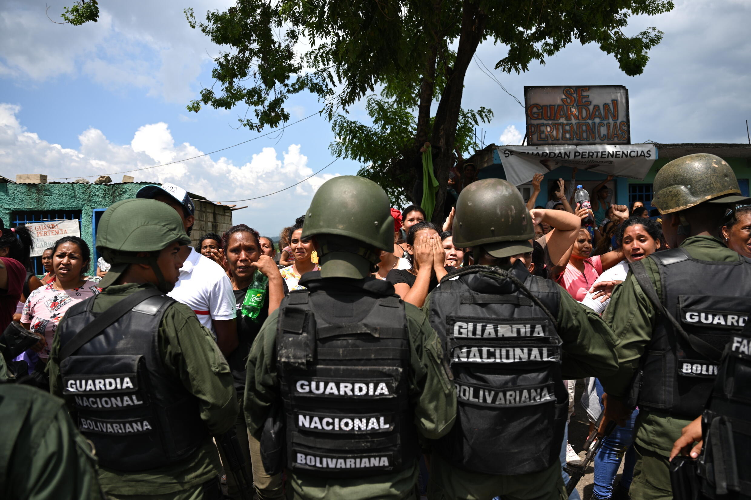 Venezuelan soldiers stand guard after seizing the Tocoron prison from the hands of a powerful gang