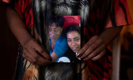 Bibi – who was adopted by Dutch parents at the age of four – holds a photo of herself and her brother.