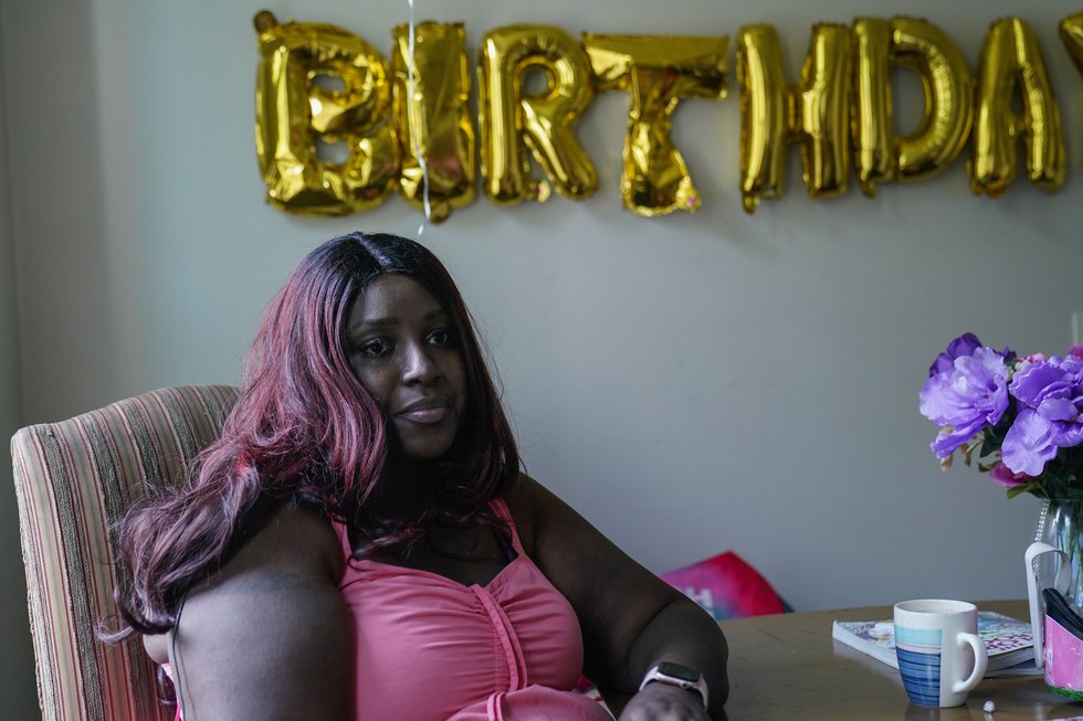 Nikuya Brooks sits at her kitchen table at home Friday, Aug. 11, 2023, in Chicago. Brooks' bond...