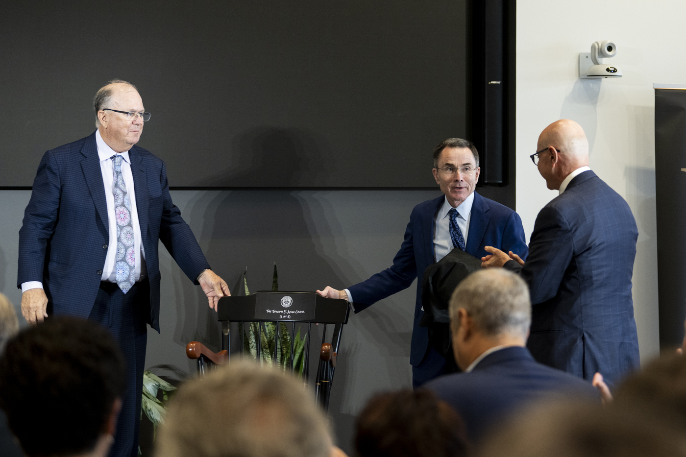 Provost Madigan, Alan McKim and President Joseph E. Aoun talk on a stage.