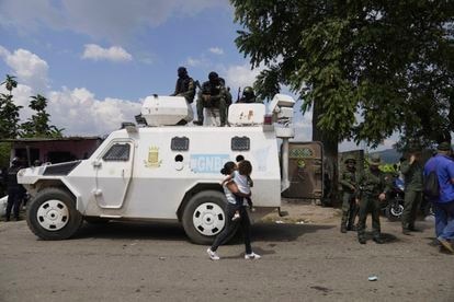 Military personnel sit on the roof of an armored vehicle during the intervention at the Tocorón penitentiary center in Tocorón, Venezuela, on Sept. 20, 2023. 