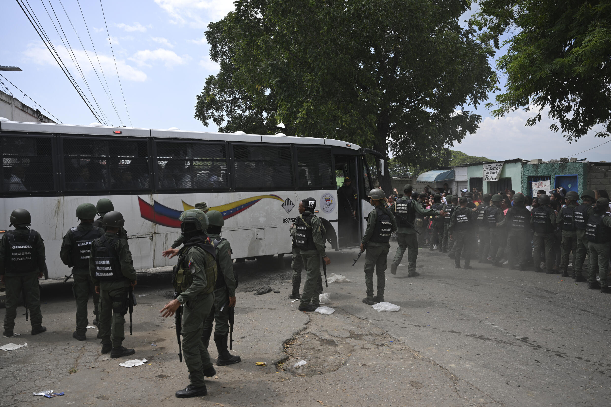 Inmates board a bus as they are transferred from the prison