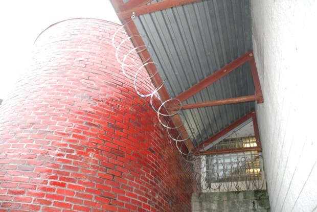 The scene in the Chester County Prison yard of the walls that Danelo Cavalcante scaled to escape, and the razor wire that protected it.