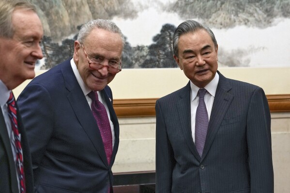 U.S. Senate Majority Leader Chuck Schumer, D-N.Y., center, and U.S. Sen. Mike Crapo, R-Idaho, left, meet with Chinese Foreign Minister Wang Yi, right, at the Diaoyutai Guest House in Beijing, Monday, Oct. 9, 2023. (AP Photo/Andy Wong, Pool)