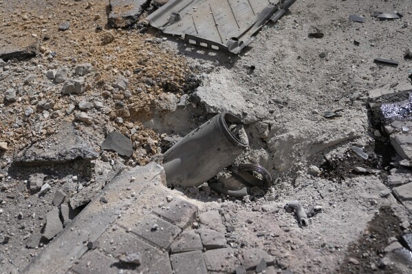 A rocket from the Gaza Strip struck a street in Ashkelon, Israel, on Saturday, Oct. 7, 2023. Palestinian militants in the Gaza Strip infiltrated Saturday into southern Israel and fired thousands of rockets into the country while Israel began striking targets in Gaza in response. (AP Photo/Ohad Zwigenberg)