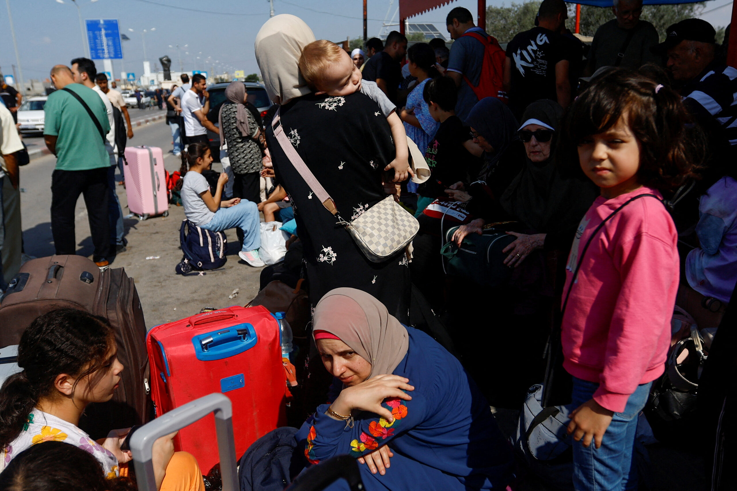 Palestinians with dual citizenship gather outside Rafah border crossing with Egypt