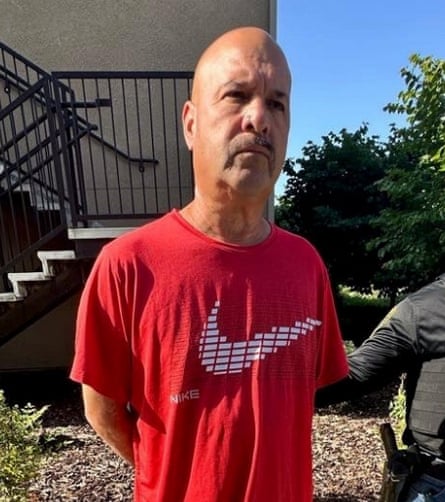 man in red t-shirt frowning