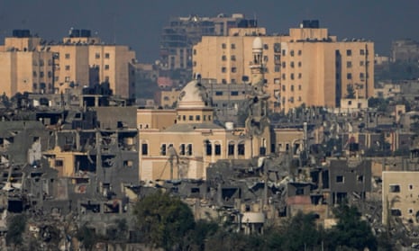 A view of destroyed houses and a mosque following Israeli strikes in the northern Gaza Strip, as seen from southern Israel