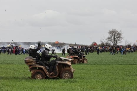 Riot mobile gendarmes, riding quad bikes, fire teargas shells towards protesters during a demonstration against the construction of a new water reserve for agricultural irrigation, in Sainte-Soline, central-western France in March.