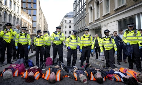 Handcuffed activists from the group Just Stop Oil lie on the road as they are arrested after they blocked a road in London in October 2022.