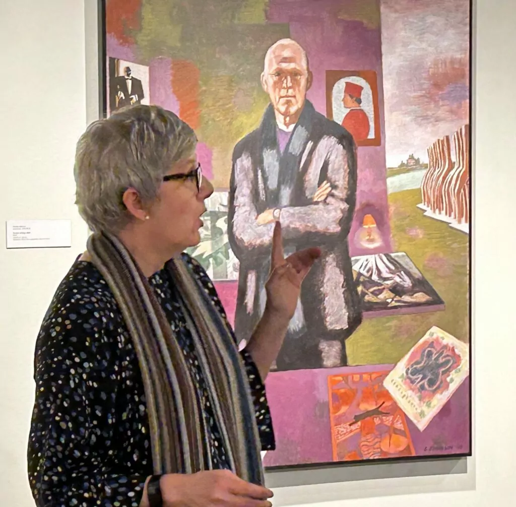 Hallie Ford curator Elizabeth Garrison pauses in front of George Johanson's portrait of Roger Hull, long-time art professor at Willamette University. Photo by: David Bates