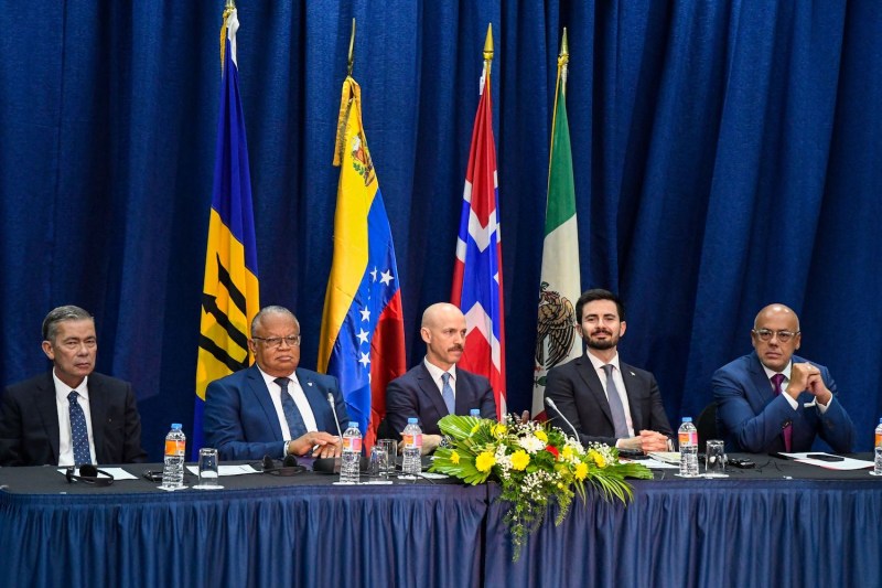 From left: Venezuelan opposition delegate Gerardo Blyde; Barbadian Foreign Minister Jerome Walcott; Dag Nylander, the director of the Norwegian Centre for Conflict Resolution; Mexican diplomat Efraín Guadarrama; and Venezuelan National Assembly leader Jorge Rodríguez pose for a photo during the signing of an agreement between the Venezuelan government and opposition at the Lloyd Erskine Sandiford Centre in Bridgetown, Barbados, on Oct. 17.