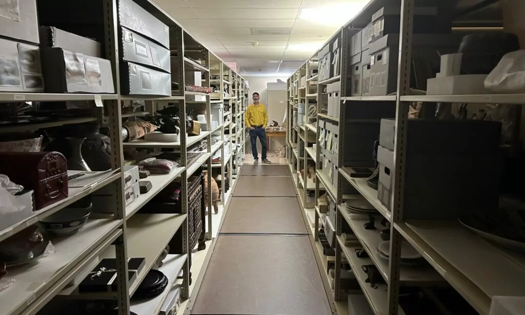 Head curator Jonathan Bucci stands amid the storage units in the basement of the Hallie Ford Museum of Art, where the roughly 10,000 pieces from the permanent collection are stored. Photo by: David Bates