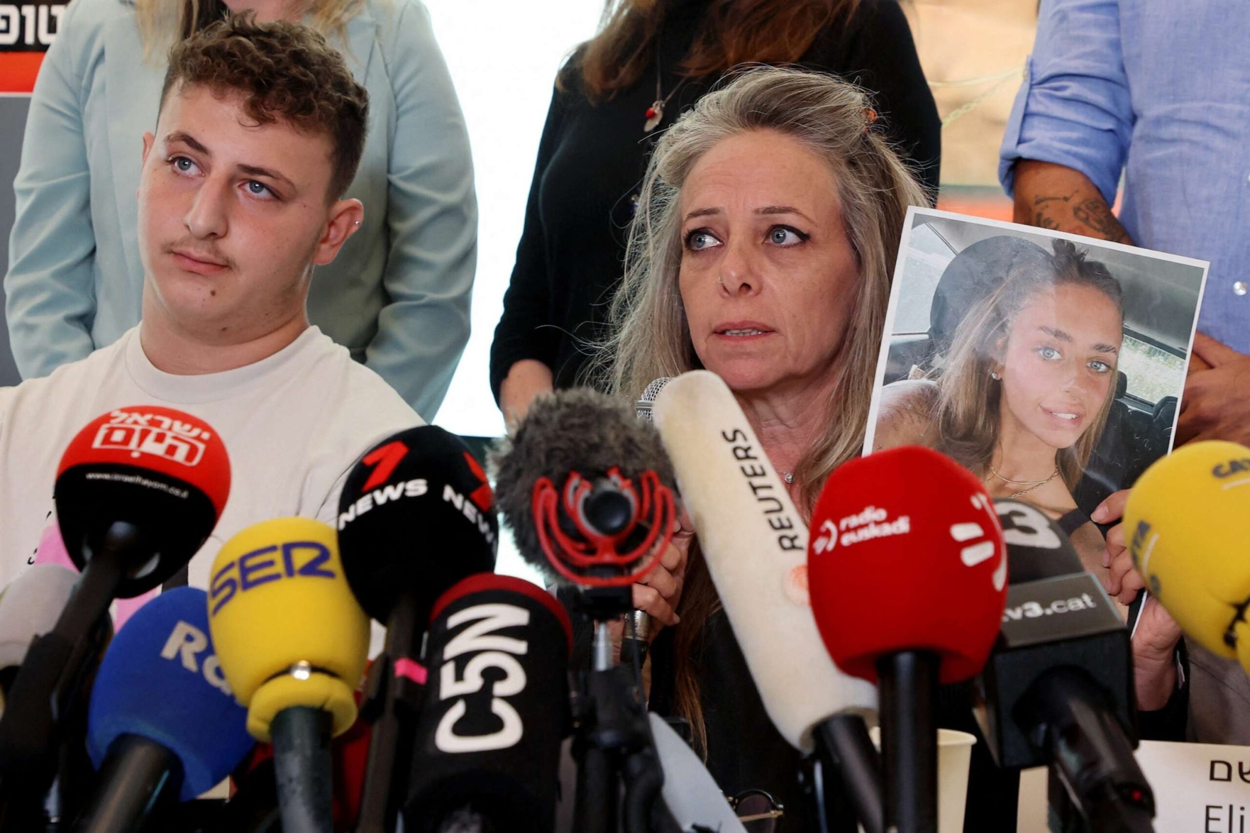 PHOTO: Keren Shem, the mother Mia Shem, held hostage by Hamas militants in Gaza, holds a photograph of her daughter as she speaks to the press in Tel Aviv on Oct. 17, 2023.