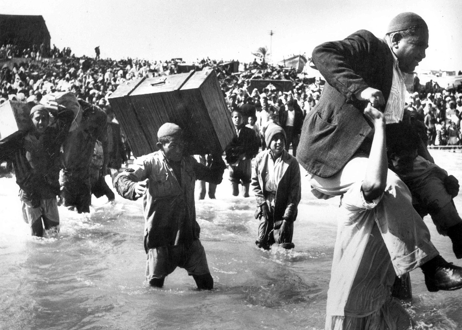 Palestinians driven from their homes by Israeli forces flee via the sea at Acre during the 1948 Palestinian exodus, known in Arabic as the Nakba.