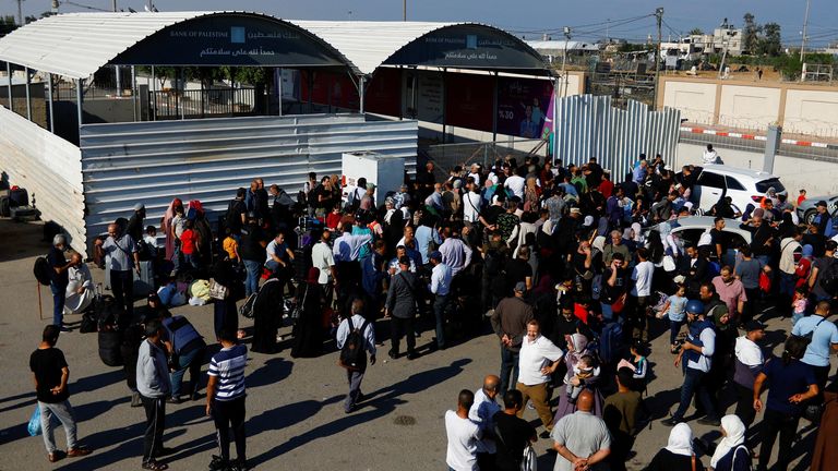 Palestinians with dual citizenship gather outside the Rafah border crossing with Egypt in the hope of getting permission to leave Gaza