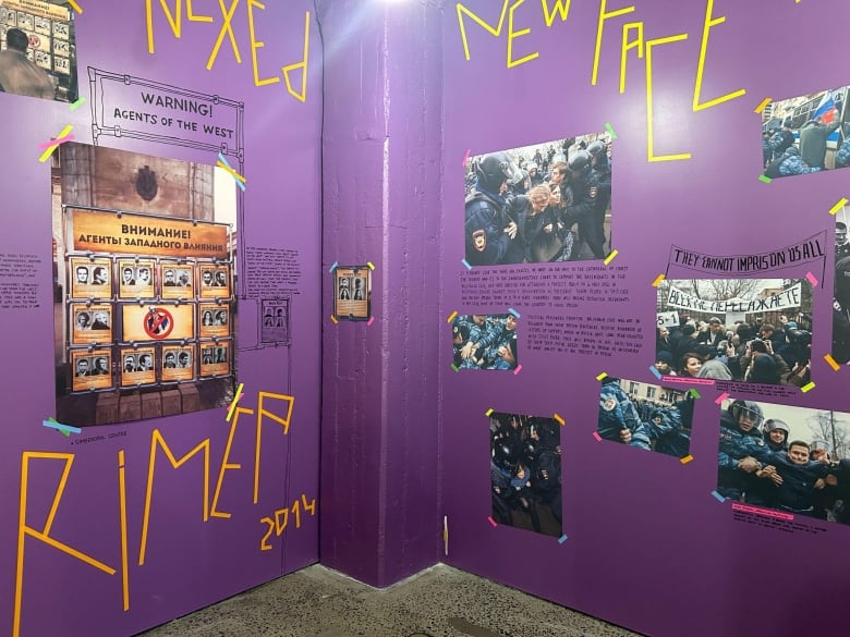 a purple wall with writing on it, photos of protests and Pussy Riot members' arrests