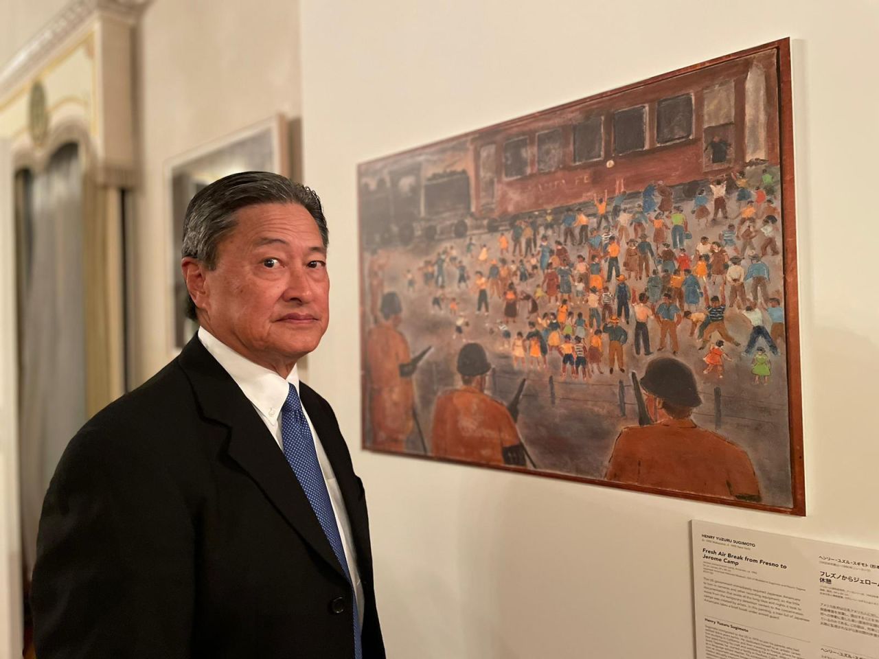 Vice chair of the Japanese American National Museum, Robert T. Fujioka, stood beside Henry Sugimoto's 