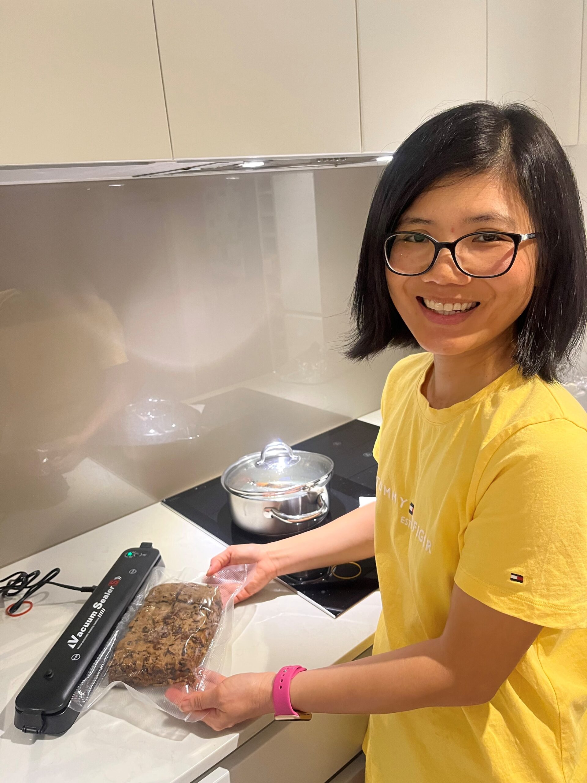 australian economist Sean Turnell's wife Ha Vu vacuum seals a cake