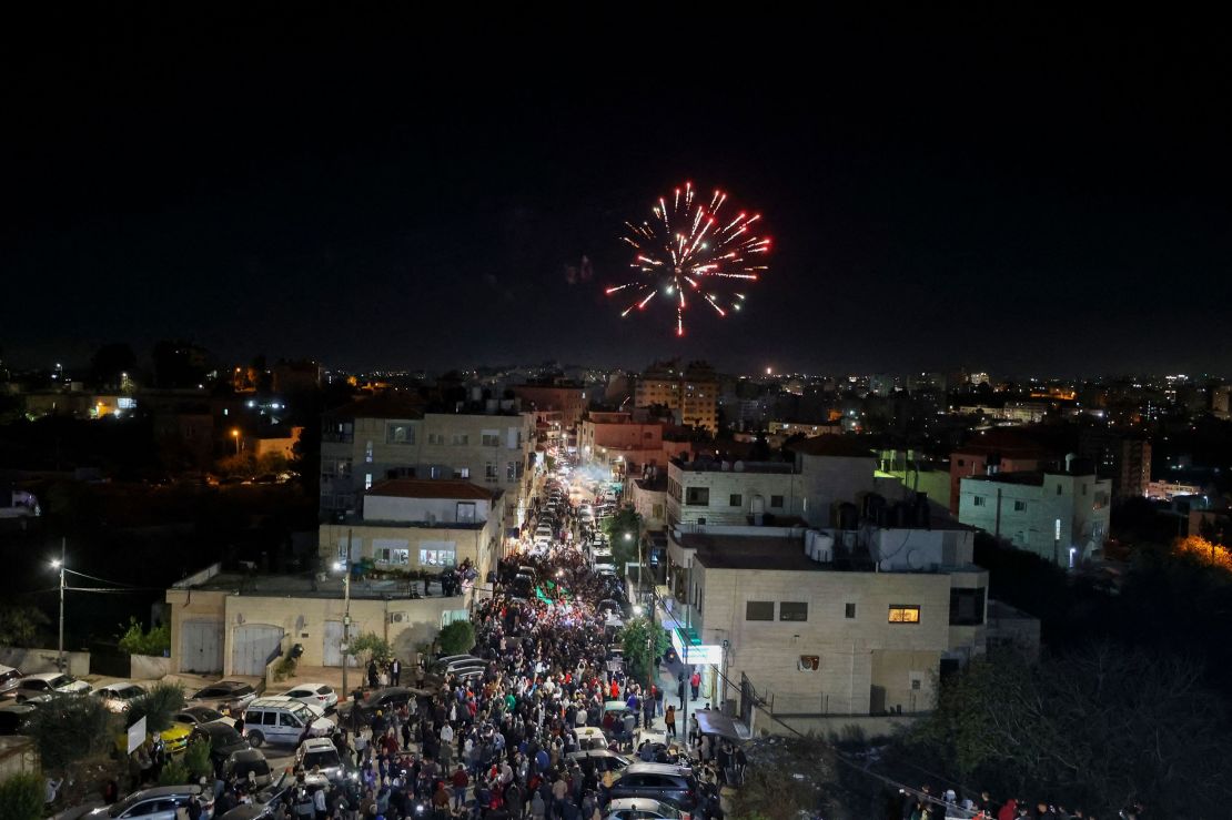 Fireworks streak across the sky as Palestinian prisoners who were released from the Israeli Ofer military facility are paraded in Beitunia, in the occupied West Bank, on Friday, November 24.