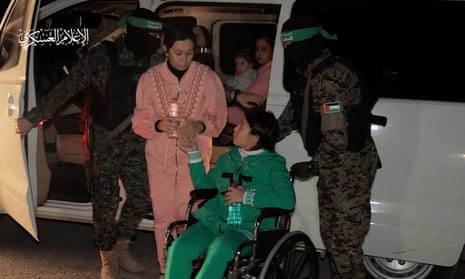 A screengrab from a Hamas video shows hostages who were abducted by the militant group during the 7 October attack on Israel are handed over to the International Committee of the Red Cross.