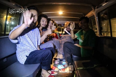 An image grab from a handout video released by Hamas shows Thai hostages waving aboard a Red Cross vehicle in the Gaza Strip as they are released after being abducted on 7 October.