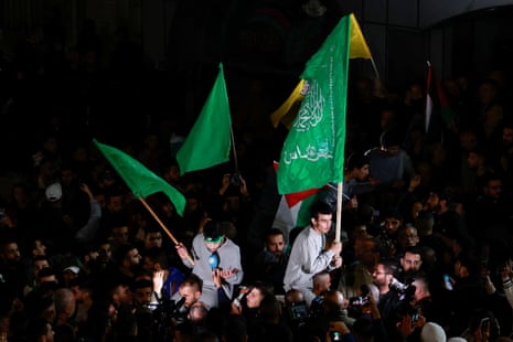 Released Palestinian prisoners wave flags as they leave the Israeli military prison.