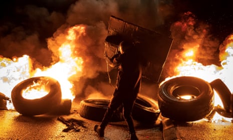 A protester burns tyres in the occupied West Bank on Monday.