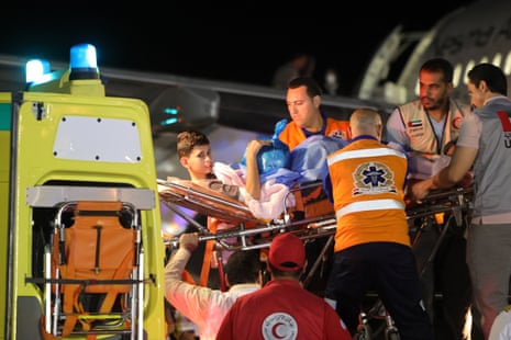 Volunteers transport a wounded Palestinian child onto a plane at Egypt’s Arish International Airport early on November 18, 2023, ahead of being evacuated to Abu Dhabi as part of a humanitarian mission organised by the United Arab Emirates.