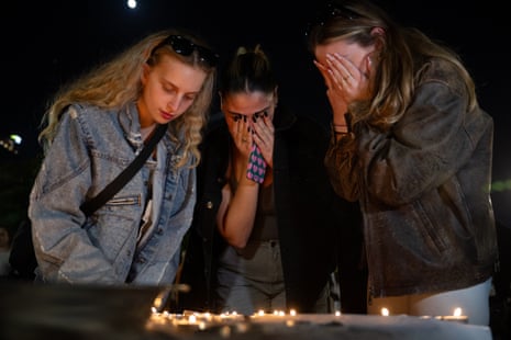 Women light shabbat candles and pray outside The Museum of Modern Art known as the 'The Hostages and Missing Square' in Tel Aviv, Israel.