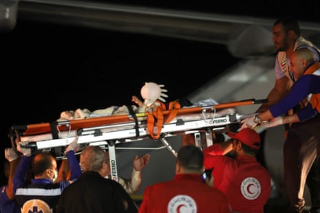 Volunteers transport a wounded Palestinian child onto a plane at Egypt’s Arish International Airport early on November 18, 2023, ahead of being evacuated to Abu Dhabi as part of a humanitarian mission organised by the United Arab Emirates.