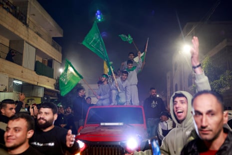 Released Palestinian prisoners wave flags atop a car as they leave the Israeli military prison, Ofer, near Ramallah in the Israeli-occupied West Bank.