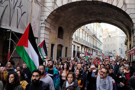 People wave Palestinian flags and shout slogans during a demonstration in support of the Palestinian people and demanding a cease fire, in Lisbon, Portugal, Saturday, Nov. 18, 2023. Thousands took part in the protest marching from the city hall to the Portuguese parliament.