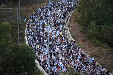 Tens of thousands of people led by the families of the hostages walk along the last stretch of Route 1 to enter Jerusalem on the fifth and final day of the March for the Hostages on November 18, 2023 in Jerusalem.